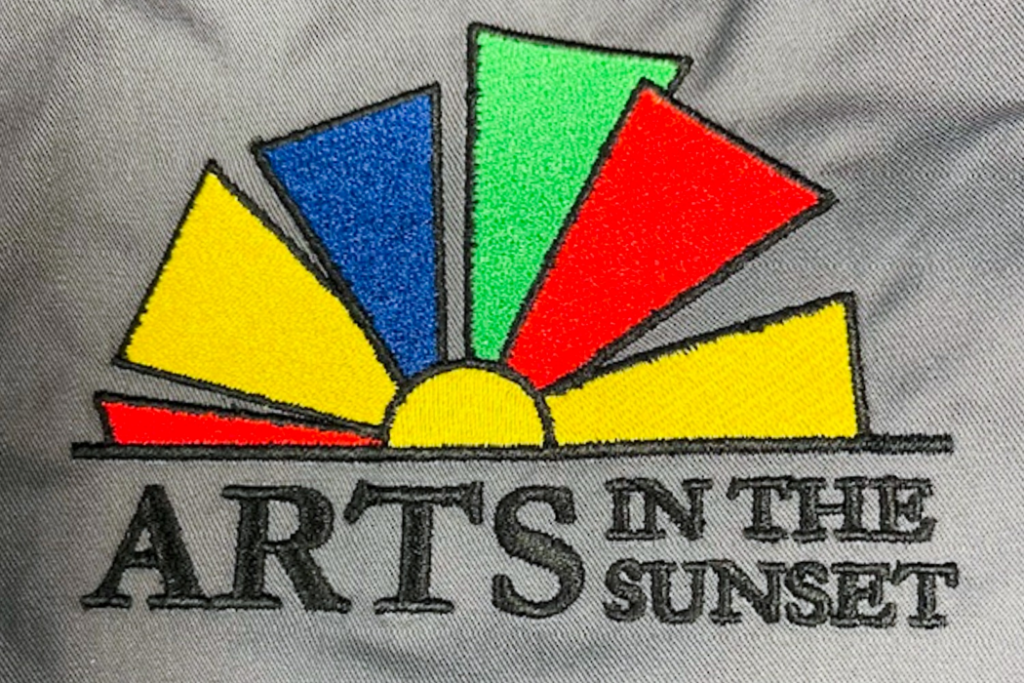 embroidered logo detail amarillo Clean edges and dense stitching show how a finished multicolor embroidered logo looks up close.